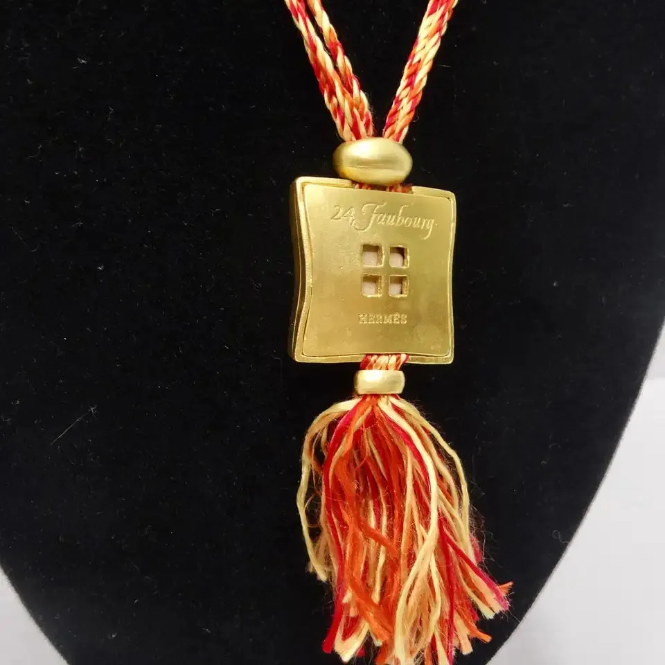 Hermes Gold Tone Pendent on Silk Yarn Chord Necklace